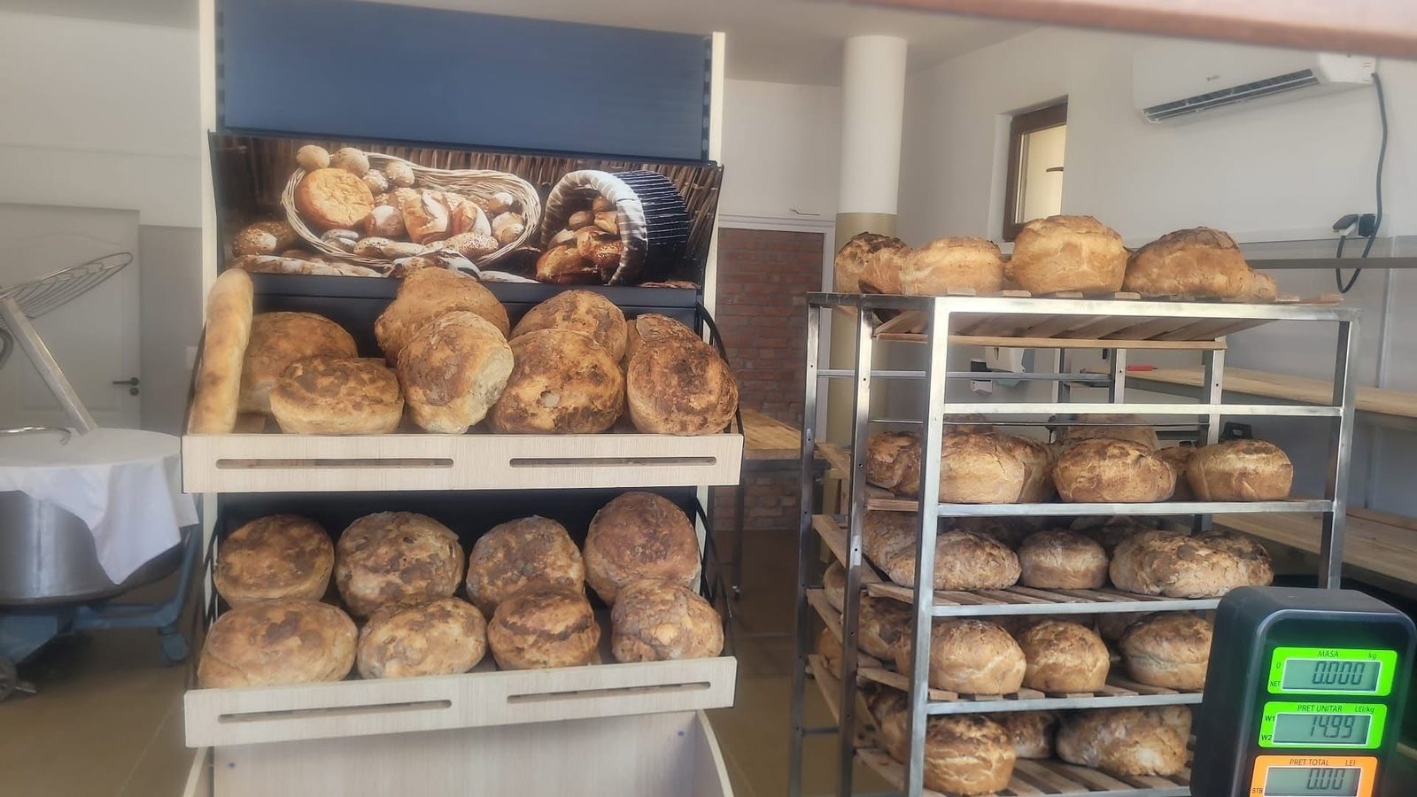 Interiorul brutăriei, cu rastelul de tăvi și cântarul